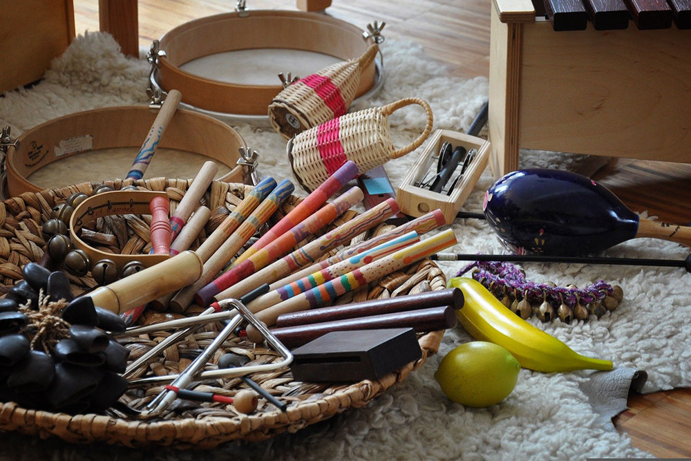 Bunte Percussioninstrumente auf einem Teppich und in einem Korb